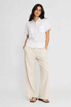 Women's white button-down shirt with contrast-stitched trim and chest pocket