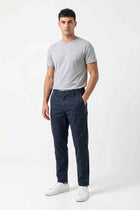 Men’s navy straight-fit casual pants on model, full-length front view
