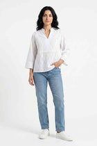 White embroidered blouse with V-neck, eyelet pattern, 3/4 sleeves on model
