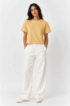 Women’s Irish cream cropped T-shirt worn with white pants