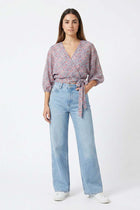 Rust printed wrap blouse with V-neck, tie waist, and 3/4 balloon sleeves