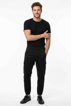 Black cargo jogger pants for men with cargo pockets, drawstring waist, tapered legs.