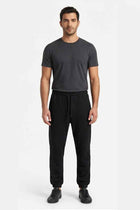 Black men’s jogger trousers with elastic waistband and drawstring, side pockets