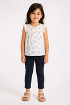 Baby girl black jeggings with ankle length and elastic waistband, worn with top