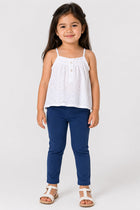 Mid-blue baby jeggings on a child, cuffed ankle hem and elastic waist