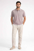 Men's polo shirt in mushroom taupe with short sleeves and two-button collar, worn front.