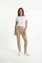 Women’s tan stretch leggings, full-length fit on model