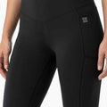 Women's black high-waist leggings with side seam panels and small logo detail