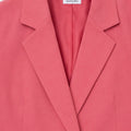 Womenâ€™s pink tailored blazer with notch lapels, flap pockets and button front