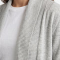 Grey ribbed knit cardigan close-up of open edge and collar area.