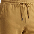 Khaki jogger waistband with drawstring cords and perforated mesh texture