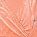Close-up of peach velvet V-neck wrap blouse with long sleeve cuff