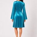 WomenÃ¢â‚¬â„¢s teal velvet wrap dress from back view with V-slit detail and flared skirt