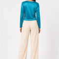 Women's teal velvet blouse with long sleeves and rounded back neckline