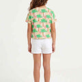 Girls' cropped graphic T-shirt, back view, light beige with green palm print, short sleeves
