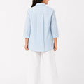 Light blue girls solid shirt, back view with button placket and long sleeves