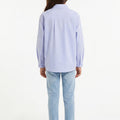 Girls light blue button-up shirt, long sleeves, back view