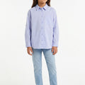 Girls light blue button-up shirt with long sleeves and collar