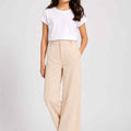 Girls wide-leg trousers in light beige, elastic waistband, front view