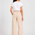 Girls wide-leg trousers in light beige, elastic waistband, back view