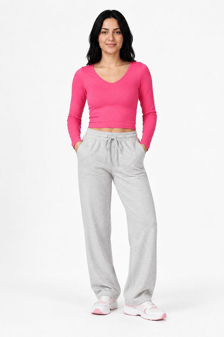 Hot pink long-sleeve women’s seamless T-shirt, front view, scoop neck, fitted knit