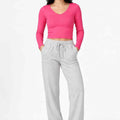 Hot pink long-sleeve women’s seamless T-shirt, front view, scoop neck, fitted knit