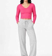 Hot pink long-sleeve women’s seamless T-shirt, front view, scoop neck, fitted knit