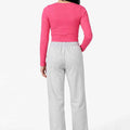 Hot pink long-sleeve women’s seamless T-shirt, back view, fitted stretch knit
