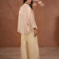 Women's wide-leg solid trousers in light cream, side view, full-length relaxed legs