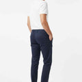 Men's navy slim-fit chinos worn standing with straight hem