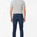 Dark blue slim-fit jeans back view with belt loops and rear pockets