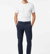 Men's navy slim-fit chinos worn full-body, straight leg