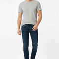 Men's slim-fit dark blue jeans with front pockets, belt loops, zip fly
