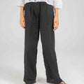 Women's black wide-leg pants with covered front, paired with embroidered shirt