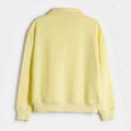 Back view of women's pale yellow polo sweatshirt with ribbed hem and cuffs