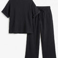 Black textured crew-neck top with wide-leg trousers, elastic waist and drawstring