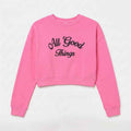 Candy pink cropped sweatshirt with 'All Good Things' front logo graphic.
