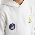 White boys hoodie close-up with sailboat patch and colorful graphic on chest