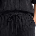 Black textured set detail: elastic waist with drawstring on wide-leg pants