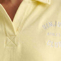 Polo sweatshirt collar detail in pale yellow with embroidered lettering on chest