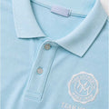 Baby blue polo shirt collar and button placket with embroidered crest