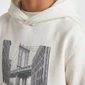 Boys' platinum hoodie close-up with Brooklyn Way skyline print and drawstring hood