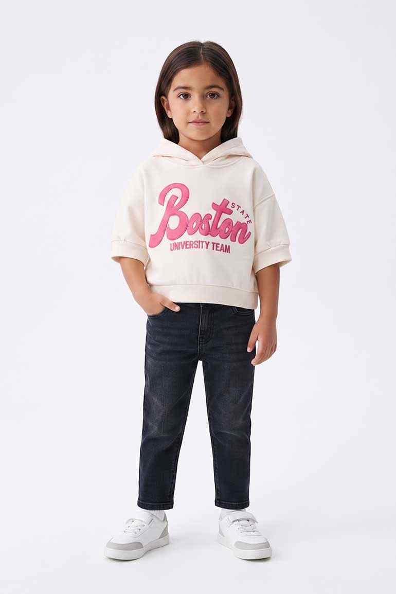 Girls' short-sleeve cream hoodie with pink Boston logo and ribbed hem, hood up.