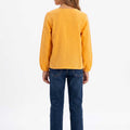 Girls mock orange blouse from behind, long sleeves with gathered cuffs and button back