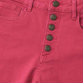Close-up of rose button-fly high-waist pants with metal buttons