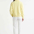 Women's pale yellow polo sweatshirt back view with ribbed cuffs and hem