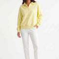 Women's pale yellow polo sweatshirt with collar and button placket, long sleeves