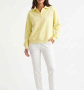 Women's pale yellow polo sweatshirt with collar and button placket, long sleeves