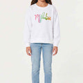 Girls' white crewneck sweatshirt with colorful Malibu logo on front
