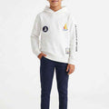 Boys white patchwork hoodie with hood, front pocket, and sailboat graphic patches